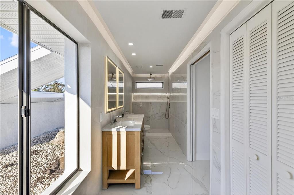 8078 Pagoda Drive Spring Hill, FL 34606 - Photo 25 of 54 a bathroom with a glass door shower and sink