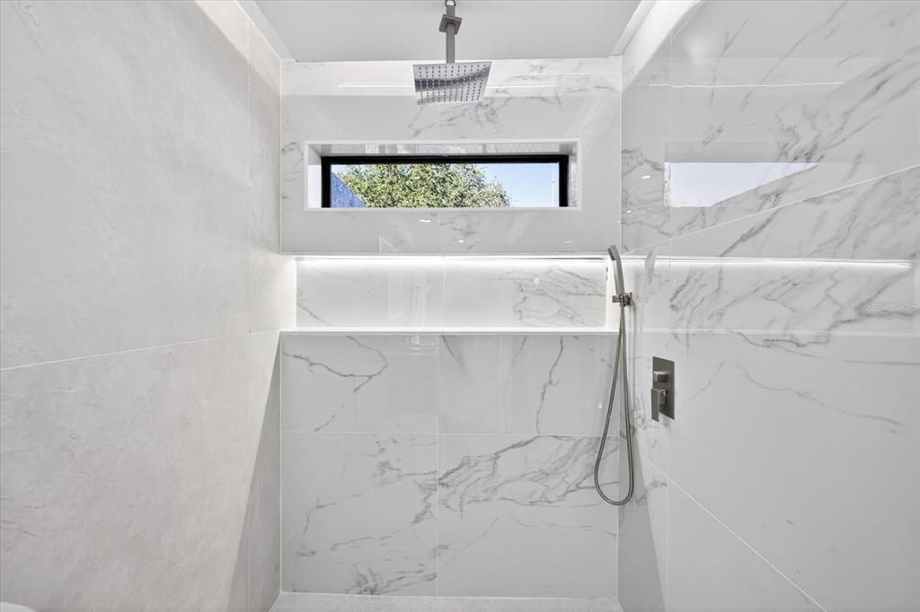 8078 Pagoda Drive Spring Hill, FL 34606 - Photo 27 of 54 a bathroom with a window and a shower