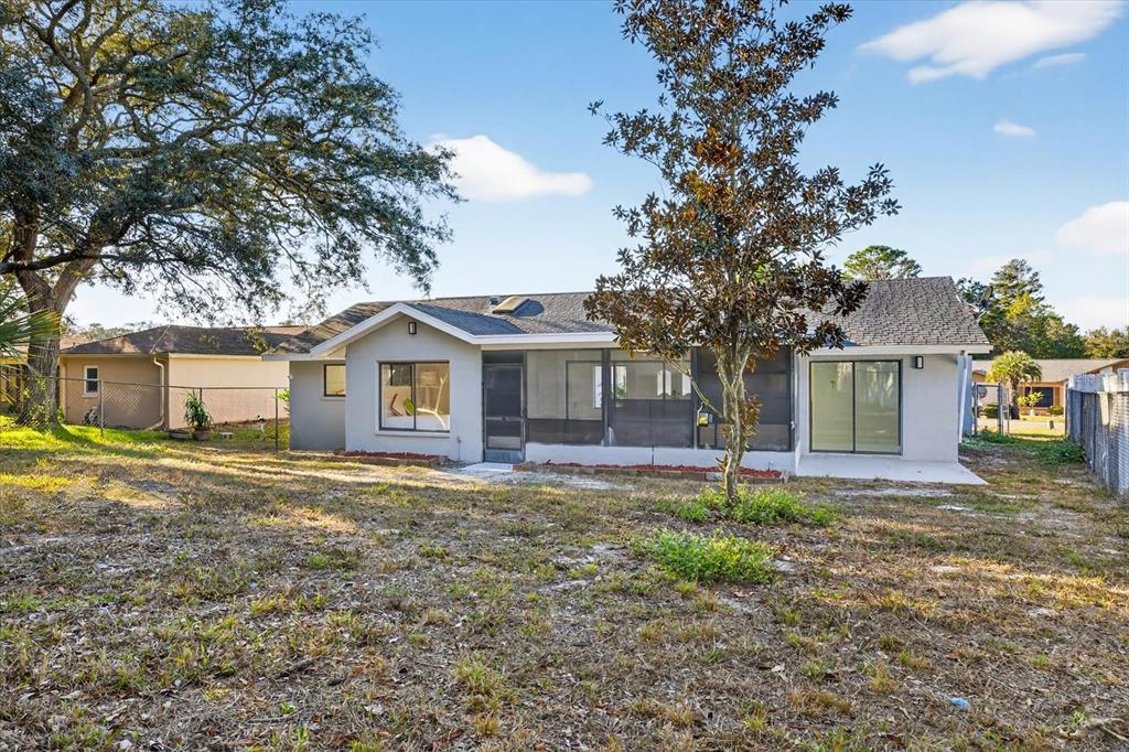 8078 Pagoda Drive Spring Hill, FL 34606 - Photo 44 of 54 a front view of a house with a yard and garage
