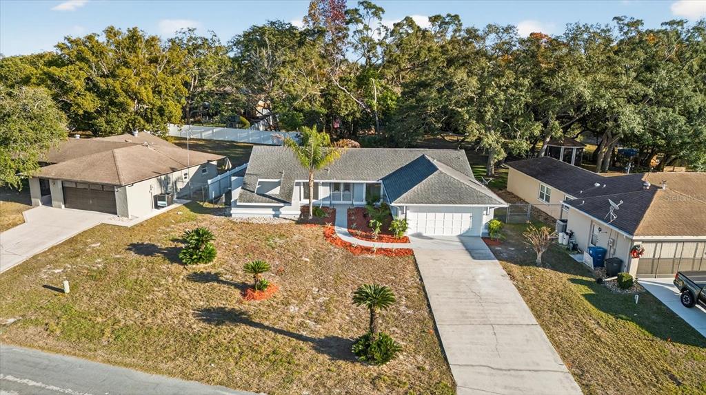 8078 Pagoda Drive Spring Hill, FL 34606 - Photo 49 of 54 an aerial view of a house with swimming pool and trees