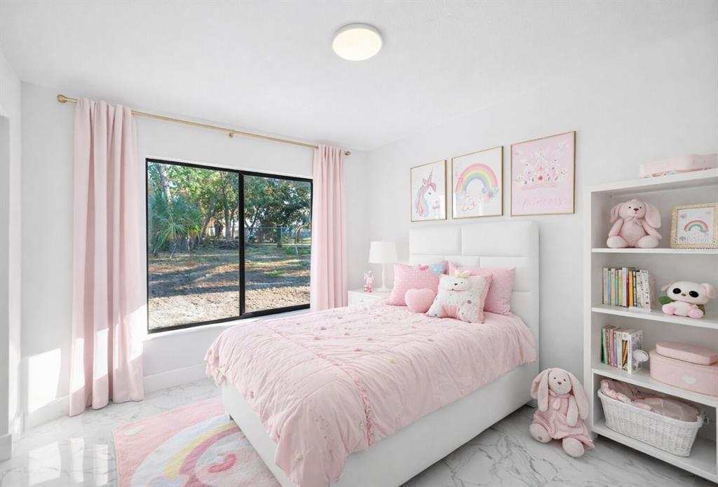 8078 Pagoda Drive Spring Hill, FL 34606 - Photo 5 of 54 a bedroom with a bed and a large window