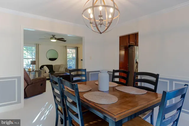 a view of a dining room with furniture and chandelier