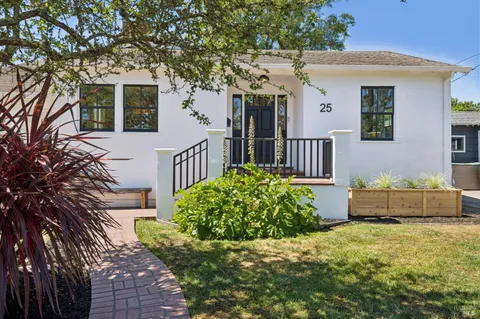 a front view of a house with a garden