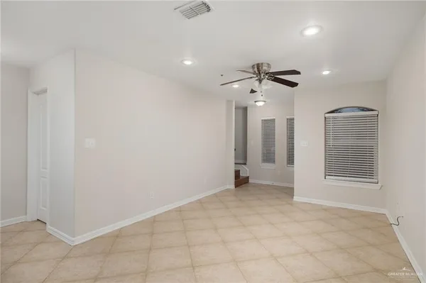 an empty room with closet and chandelier fan