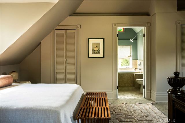 a bedroom with a bed and a table