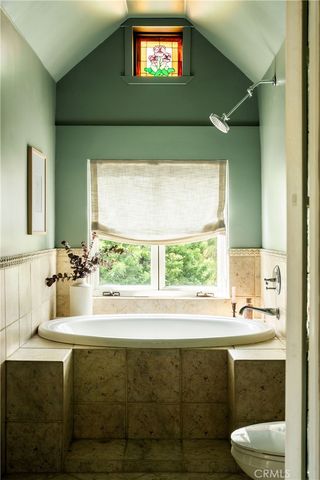 a bathroom with a sink mirror and a window