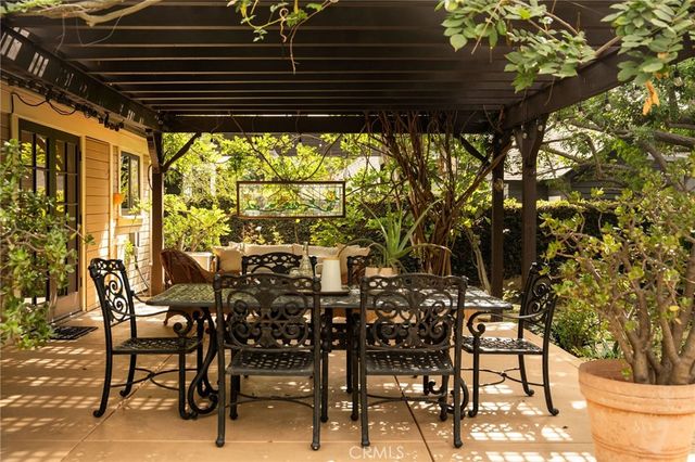 a view of a patio with table and chairs and potted plants