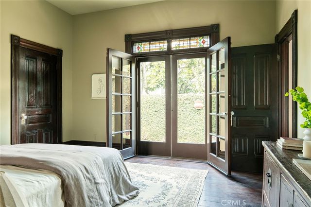 a bedroom with a bed and a large window