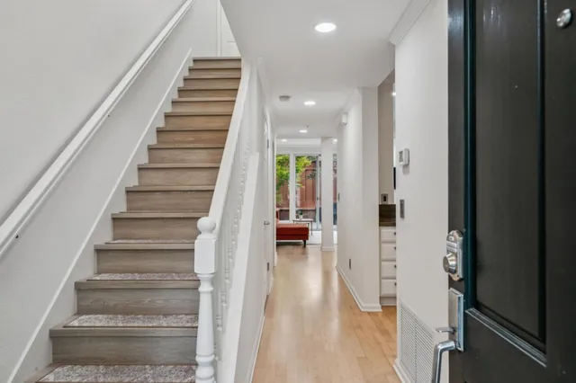 a view of entryway and hall with wooden floor