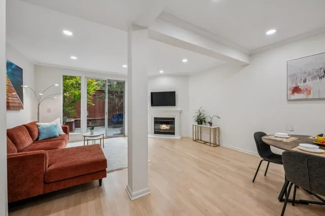 a living room with furniture a fireplace and a flat screen tv