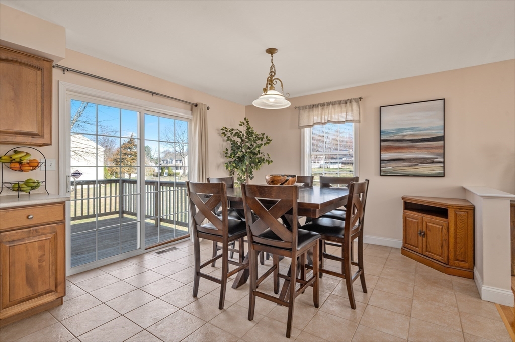 104 Overlook Terrace Dracut, MA 01826 - Photo 11 of 39 a dining room with furniture a chandelier and window