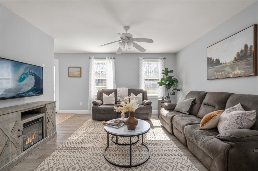104 Overlook Terrace Dracut, MA 01826 - Photo 18 of 39 a living room with furniture a fireplace and a flat screen tv
