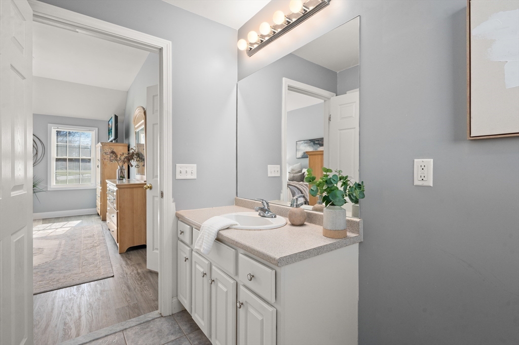 104 Overlook Terrace Dracut, MA 01826 - Photo 28 of 39 a bathroom with a sink a mirror and a shower