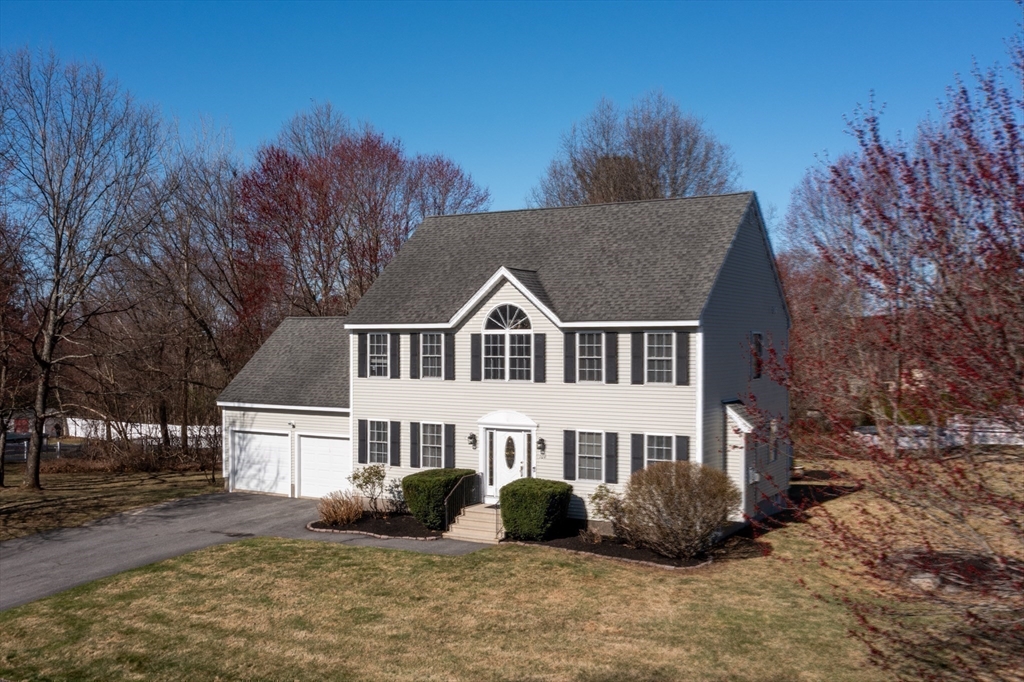 104 Overlook Terrace Dracut, MA 01826 - Photo 3 of 39 a front view of a house with a yard
