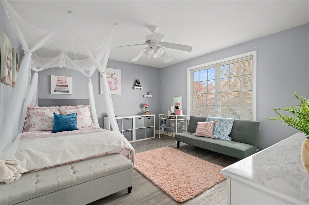 104 Overlook Terrace Dracut, MA 01826 - Photo 32 of 39 a bedroom with a bed a couch and potted plant with the outer view
