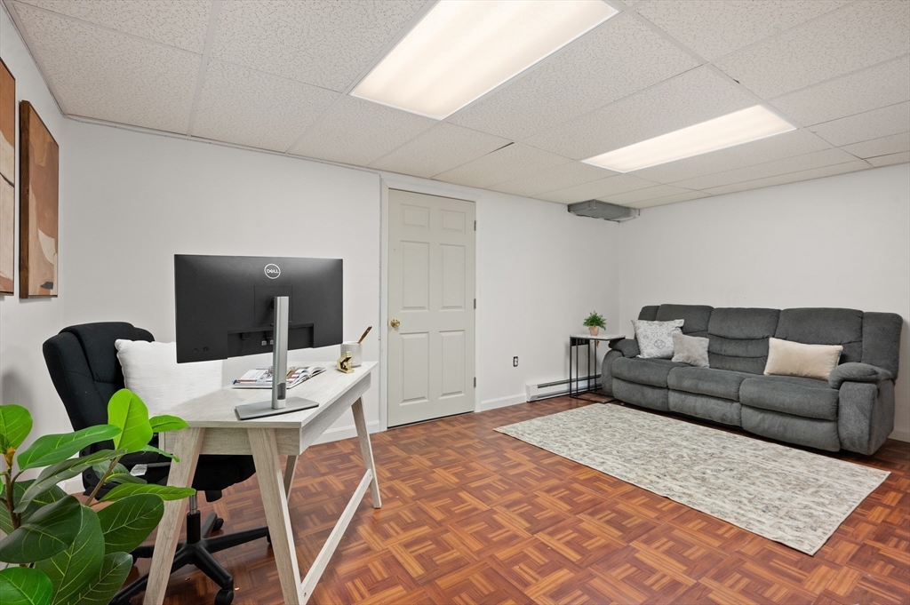 104 Overlook Terrace Dracut, MA 01826 - Photo 36 of 39 a living room with furniture a flat screen tv and a table