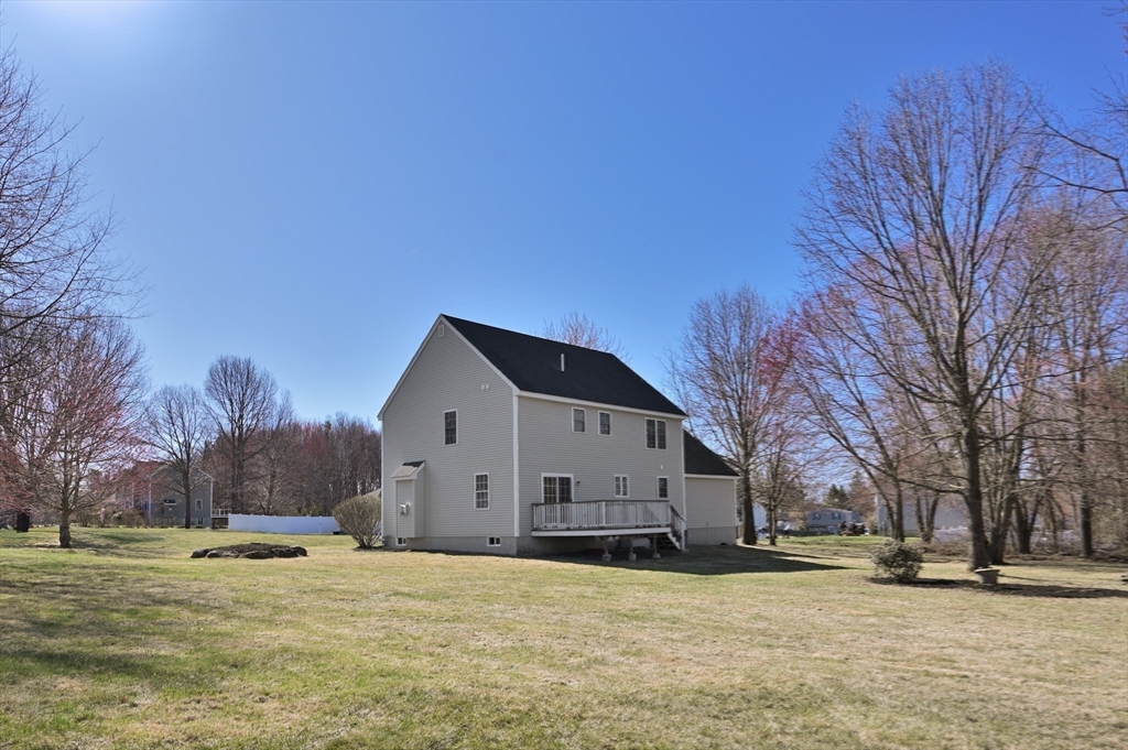 104 Overlook Terrace Dracut, MA 01826 - Photo 4 of 39 a view of a house with a yard covered in snow