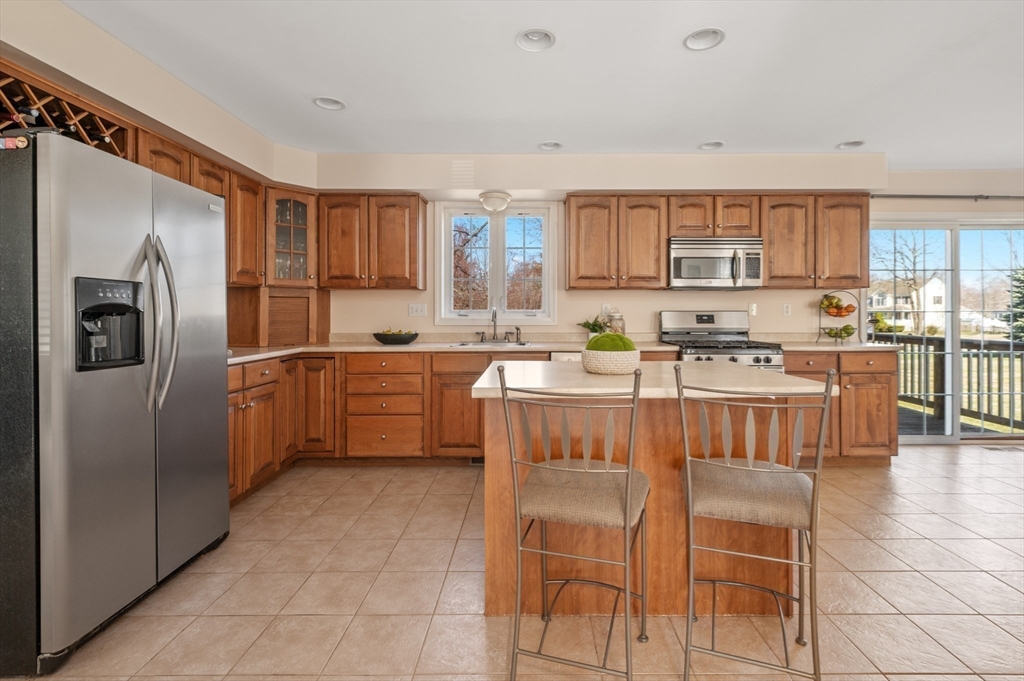 104 Overlook Terrace Dracut, MA 01826 - Photo 6 of 39 a kitchen with stainless steel appliances granite countertop a stove a sink a microwave a refrigerator and cabinets