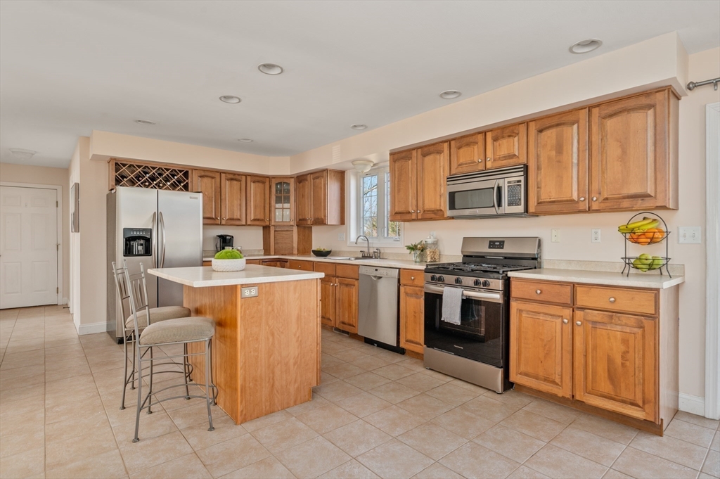 104 Overlook Terrace Dracut, MA 01826 - Photo 7 of 39 a kitchen with a refrigerator stove top oven and sink