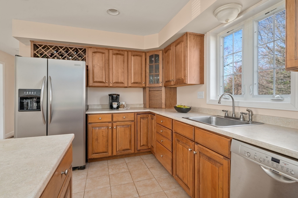 104 Overlook Terrace Dracut, MA 01826 - Photo 8 of 39 a kitchen with a sink a refrigerator and cabinets