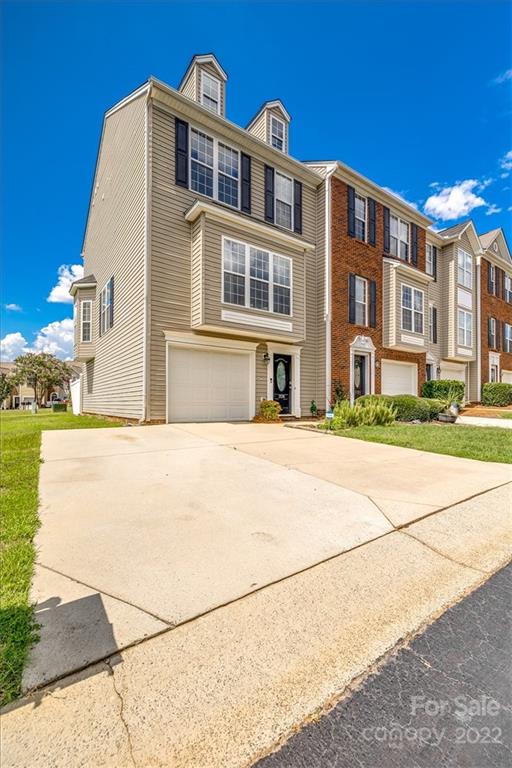 2126 Midnight Blue Lane Fort Mill, SC 29708 - Photo 1 of 35 a front view of a building with a garden