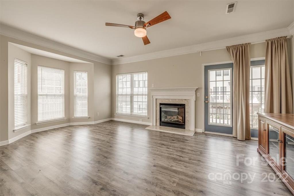 2126 Midnight Blue Lane Fort Mill, SC 29708 - Photo 12 of 35 wooden floor fireplace and windows in an empty room