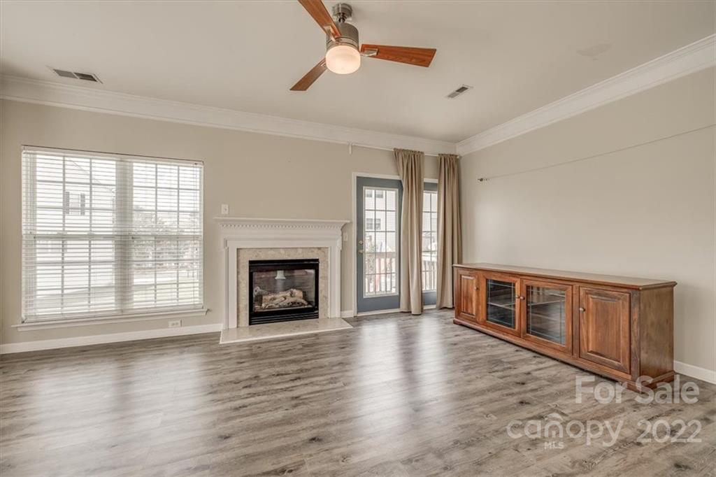 2126 Midnight Blue Lane Fort Mill, SC 29708 - Photo 13 of 35 wooden floor fireplace and windows in an empty room