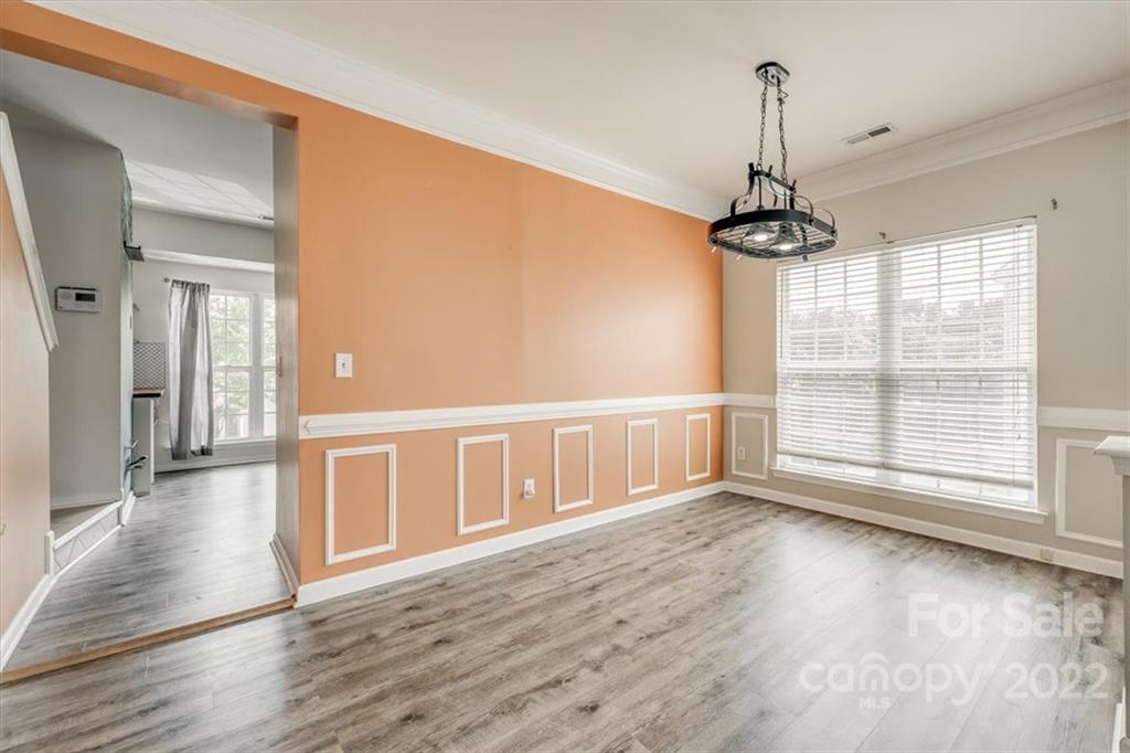 2126 Midnight Blue Lane Fort Mill, SC 29708 - Photo 16 of 35 a view of an empty room with wooden floor and a window