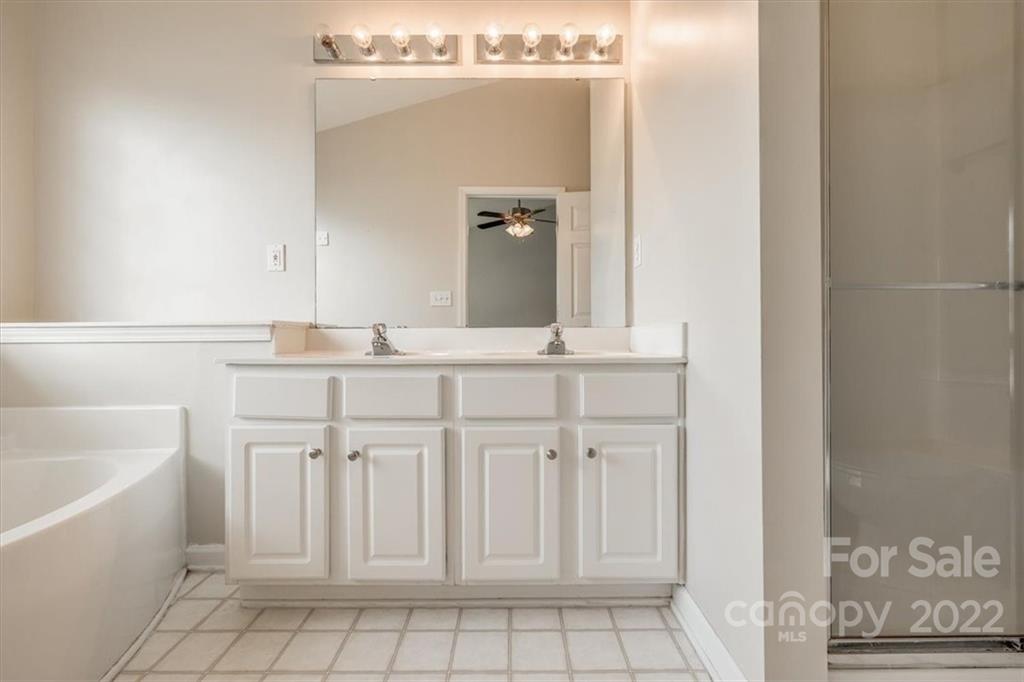2126 Midnight Blue Lane Fort Mill, SC 29708 - Photo 32 of 35 a bathroom with a sink a vanity and mirror
