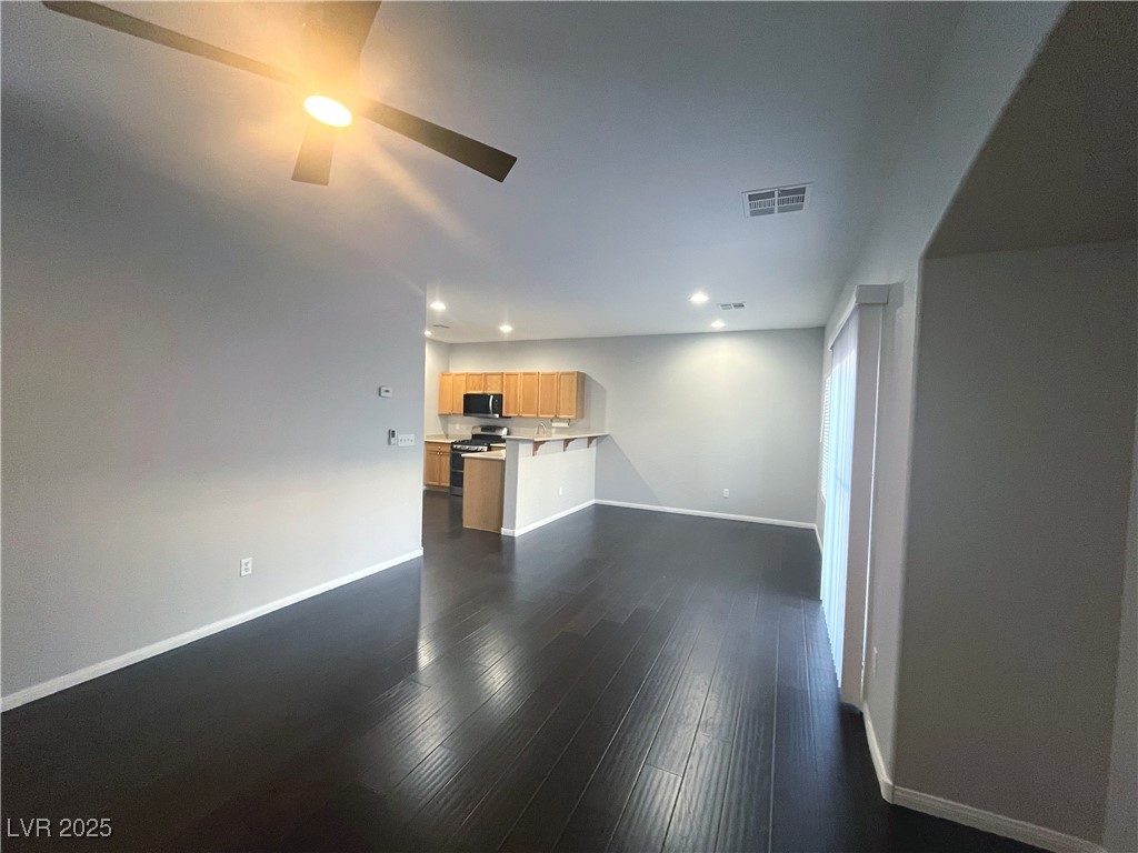 231 Spectacular Street Henderson, NV 89052 - Photo 23 of 66 Living room w/wood laminate flooring, ceiling fan & light & entertainment niche.