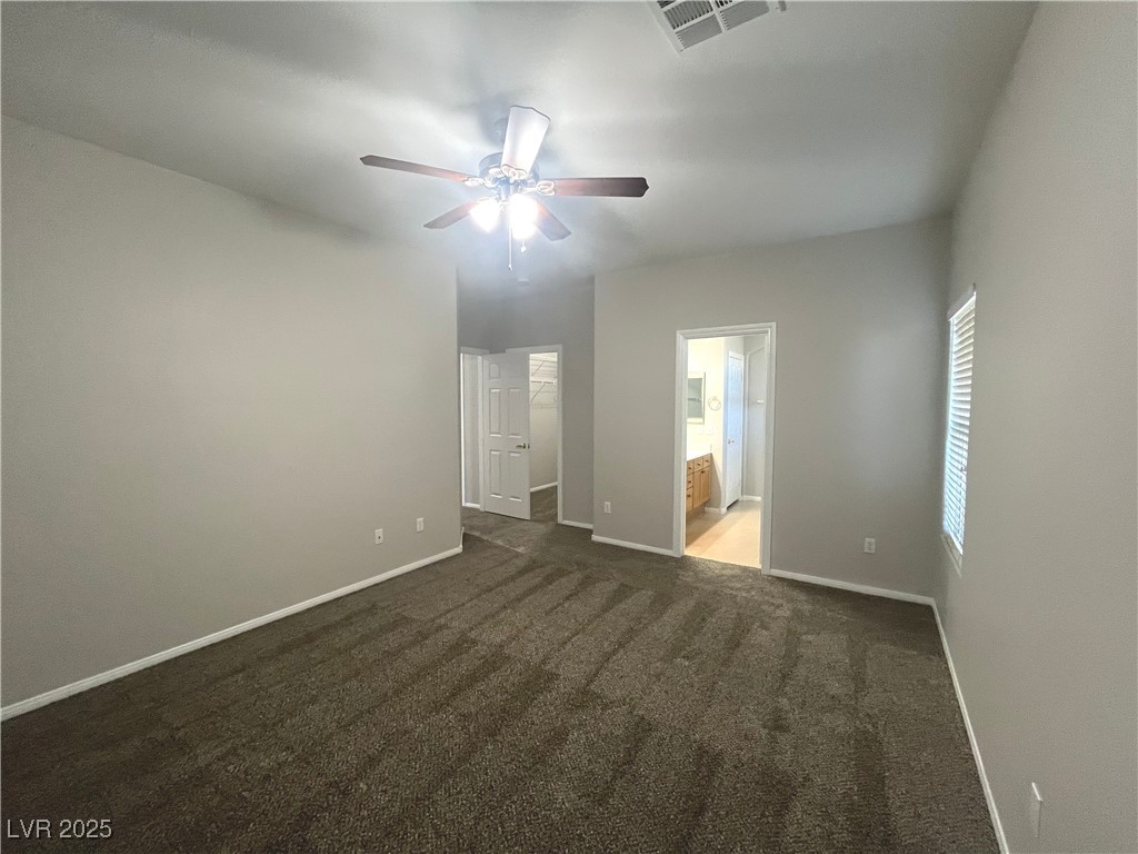 231 Spectacular Street Henderson, NV 89052 - Photo 25 of 66 Primary bed with carpet, ceiling fan and ceiling light and walk in closet
