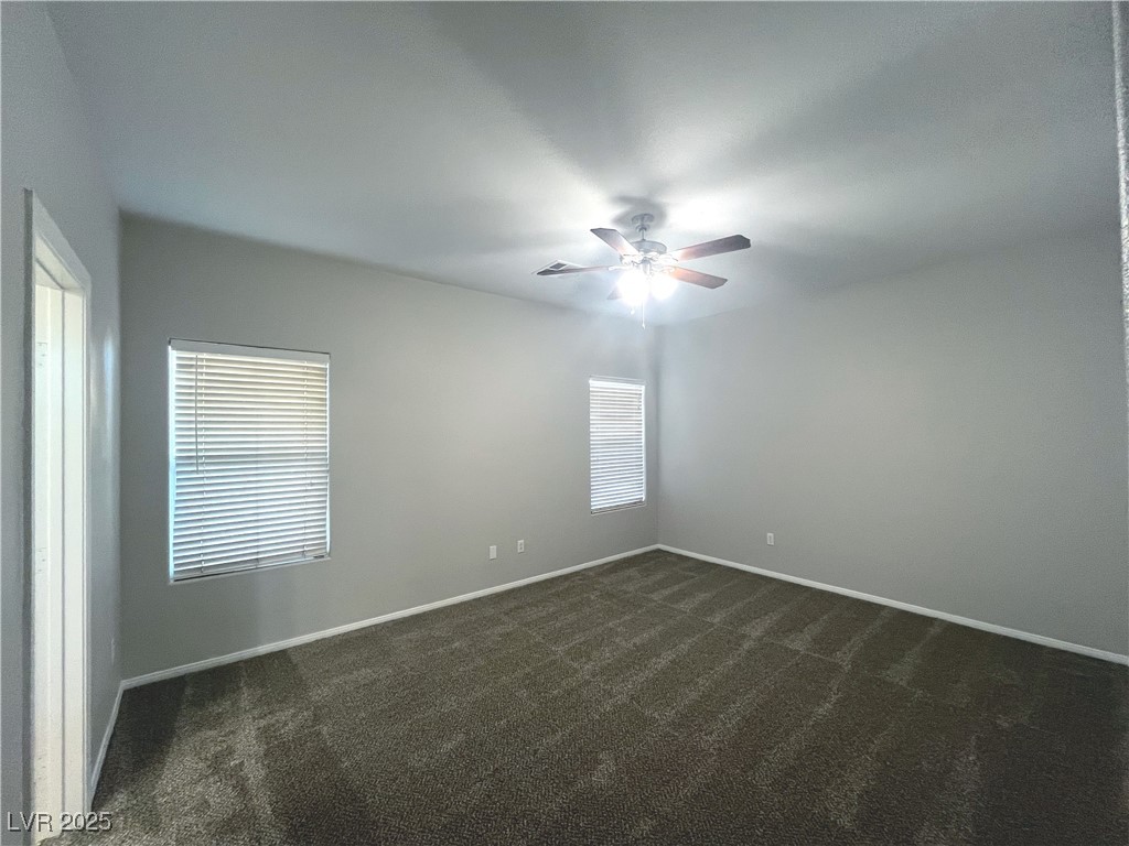 231 Spectacular Street Henderson, NV 89052 - Photo 27 of 66 Primary bed with carpet, ceiling fan and ceiling light and walk in closet