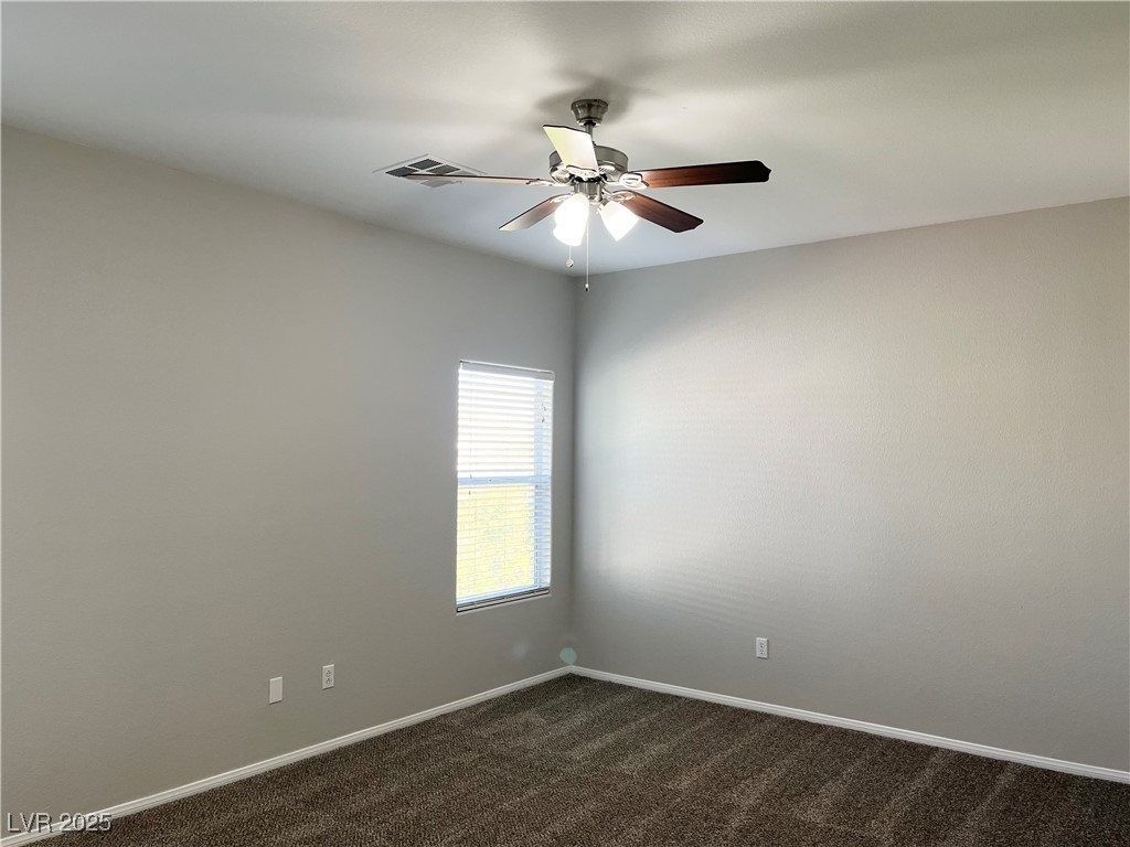 231 Spectacular Street Henderson, NV 89052 - Photo 28 of 66 Primary bed with carpet, ceiling fan and ceiling light and walk in closet
