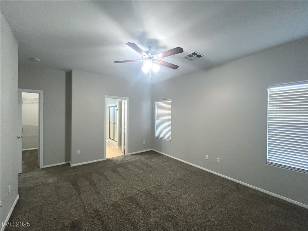 231 Spectacular Street Henderson, NV 89052 - Photo 30 of 66 Primary bed with carpet, ceiling fan and ceiling light and walk in closet