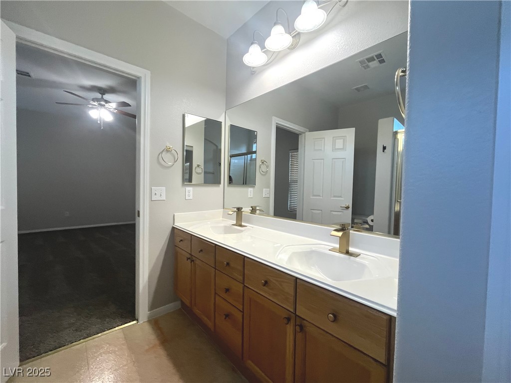 231 Spectacular Street Henderson, NV 89052 - Photo 35 of 66 Primary bath with double sinks, oak cabinets, cultured marble countertop, walk in shower & linen closet