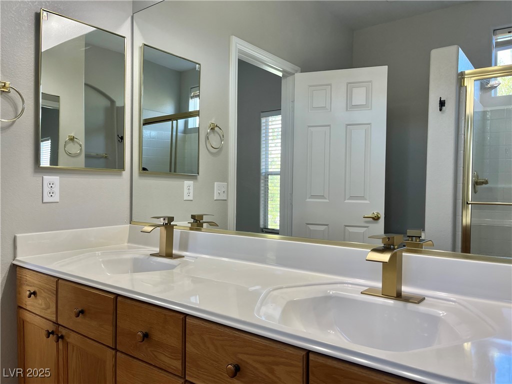231 Spectacular Street Henderson, NV 89052 - Photo 37 of 66 Primary bath with double sinks, oak cabinets, cultured marble countertop, walk in shower & linen closet