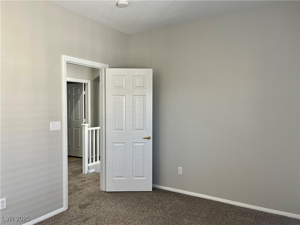 231 Spectacular Street Henderson, NV 89052 - Photo 39 of 66 Bed 2 with ceiling light, carpet, walk in closet and Jack and Jill bathroom