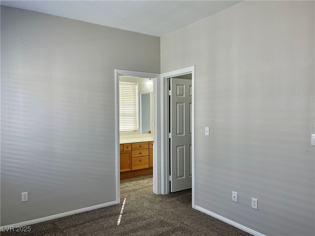 231 Spectacular Street Henderson, NV 89052 - Photo 41 of 66 Bed 2 with ceiling light, carpet, walk in closet and Jack and Jill bathroom
