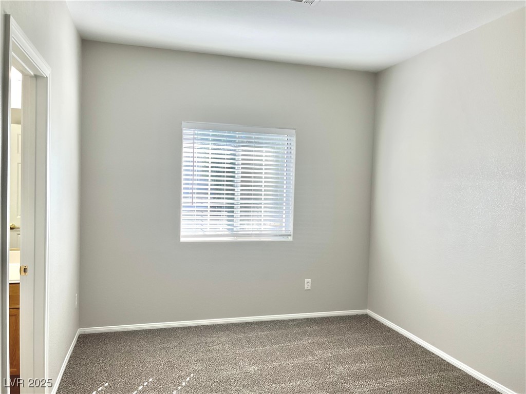 231 Spectacular Street Henderson, NV 89052 - Photo 51 of 66 Bed 3 with ceiling light, carpet, walk in closet and Jack and Jill bathroom