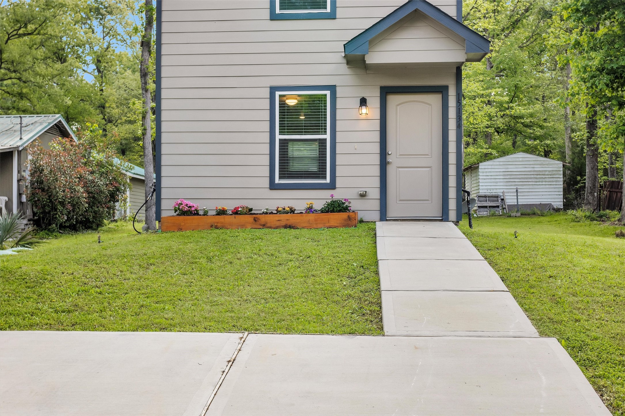15134 Austin Road Willis, TX 77378 - Photo 2 of 20 a front view of a house with a yard