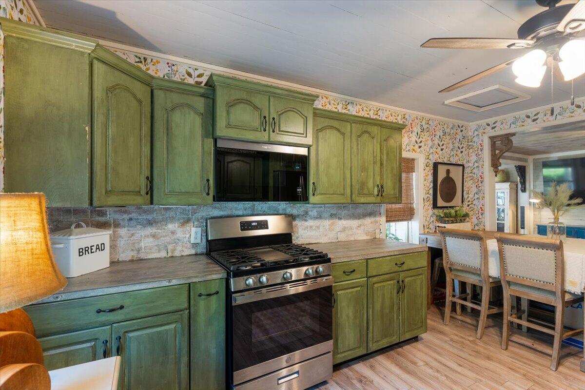 3562 Bob Tolbert Road Navarre, FL 32566 - Photo 15 of 55 a kitchen with cabinets a sink and appliances