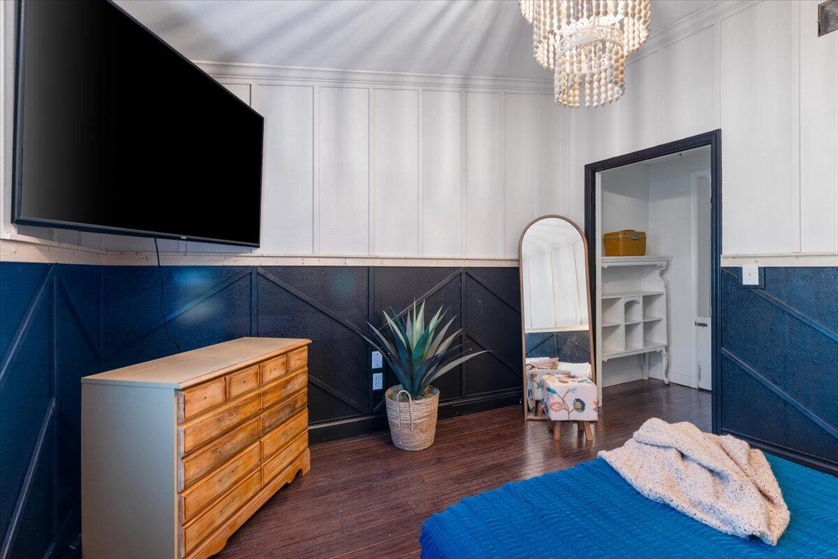 3562 Bob Tolbert Road Navarre, FL 32566 - Photo 23 of 55 a kitchen with stainless steel appliances granite countertop a sink a microwave a dining table and chairs with wooden floor