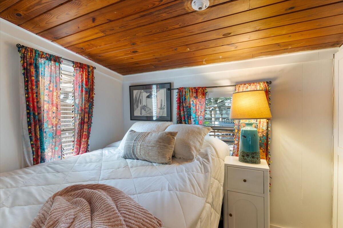 3562 Bob Tolbert Road Navarre, FL 32566 - Photo 24 of 55 a bedroom with a bed and a dresser next to a window