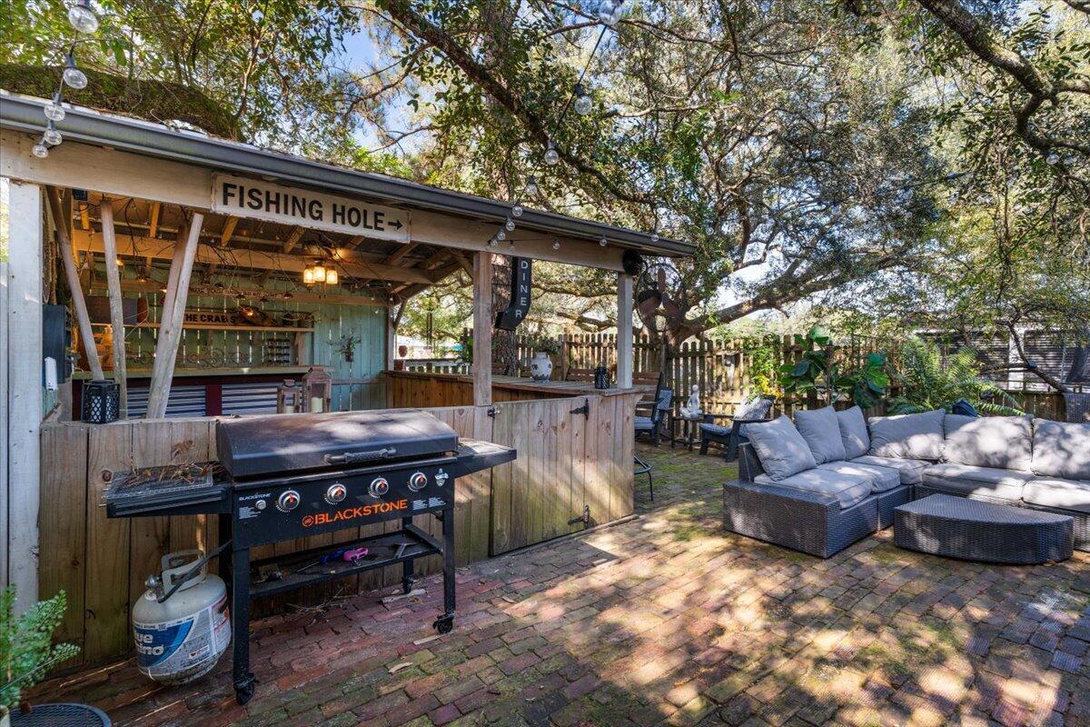 3562 Bob Tolbert Road Navarre, FL 32566 - Photo 27 of 55 a view of a backyard with a large tree and furniture