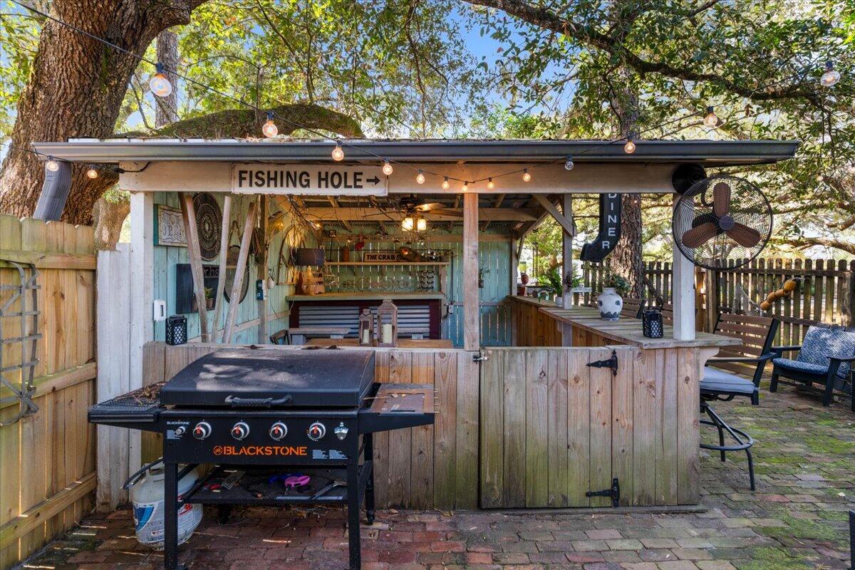 3562 Bob Tolbert Road Navarre, FL 32566 - Photo 28 of 55 a view of a chairs and table in a patio