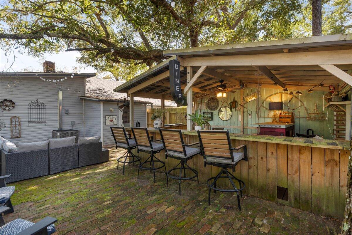 3562 Bob Tolbert Road Navarre, FL 32566 - Photo 31 of 55 a view of a patio with table and chairs with wooden floor and fence