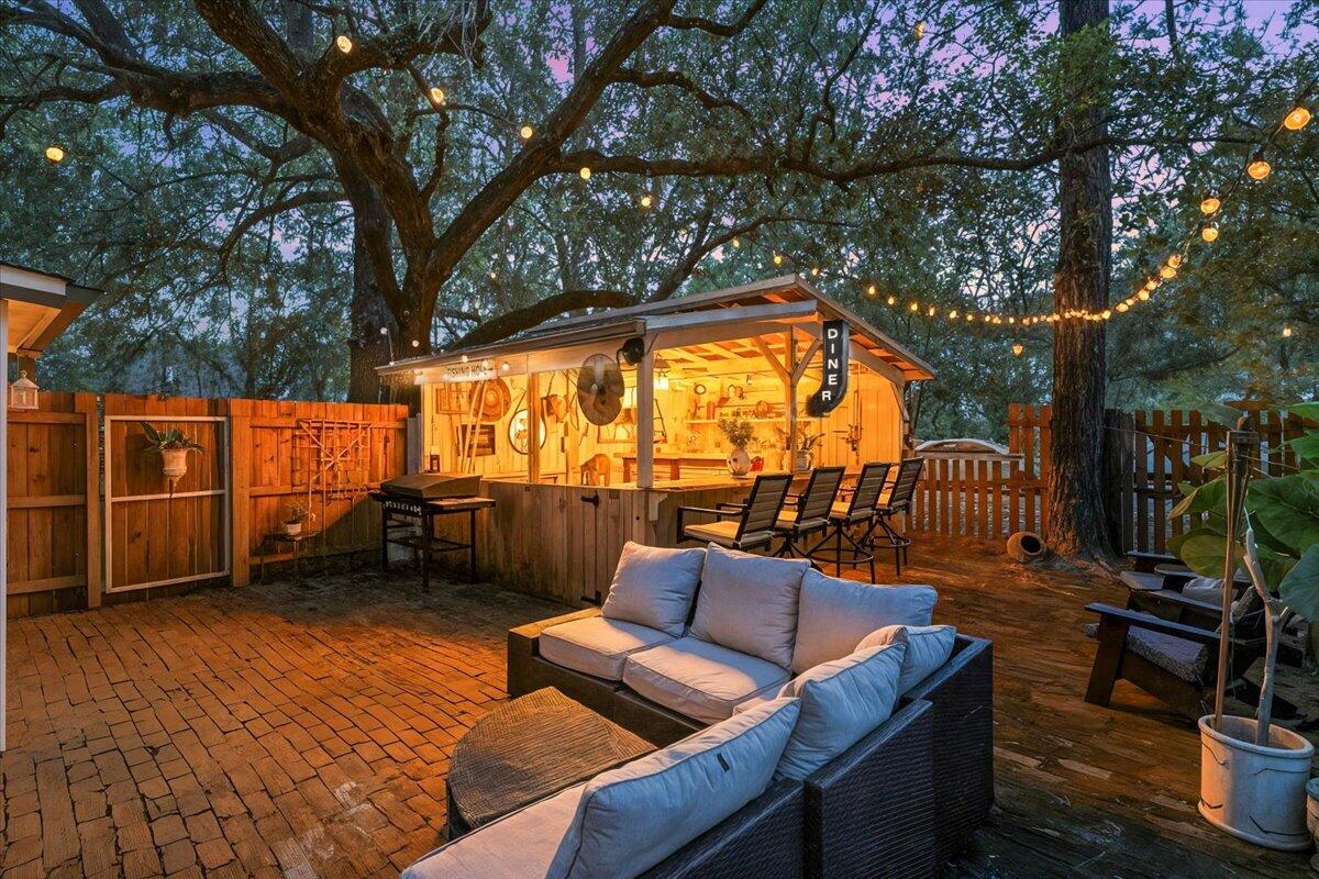 3562 Bob Tolbert Road Navarre, FL 32566 - Photo 32 of 55 a backyard of a house with outdoor seating