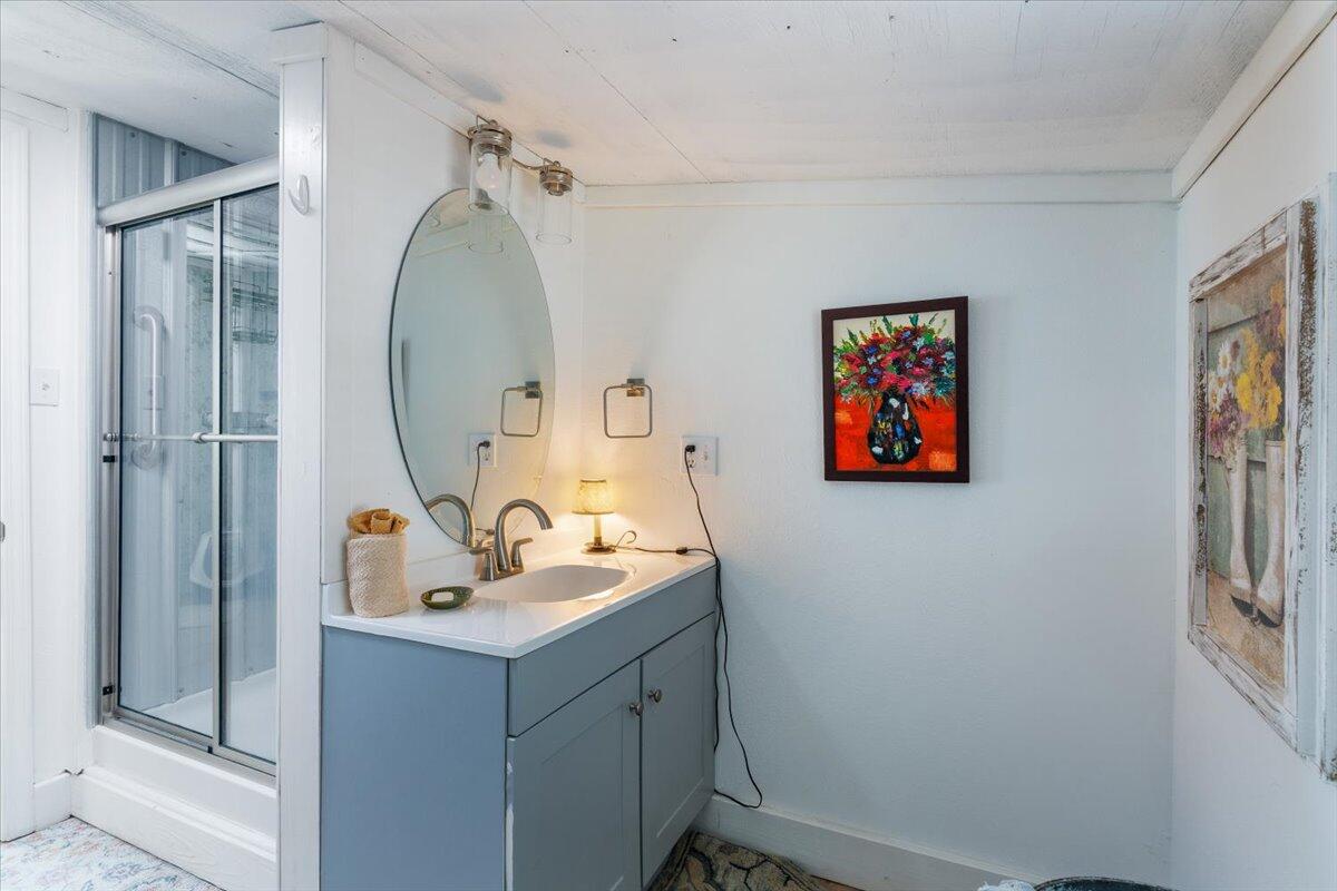 3562 Bob Tolbert Road Navarre, FL 32566 - Photo 45 of 55 a bathroom with a sink mirror and vanity
