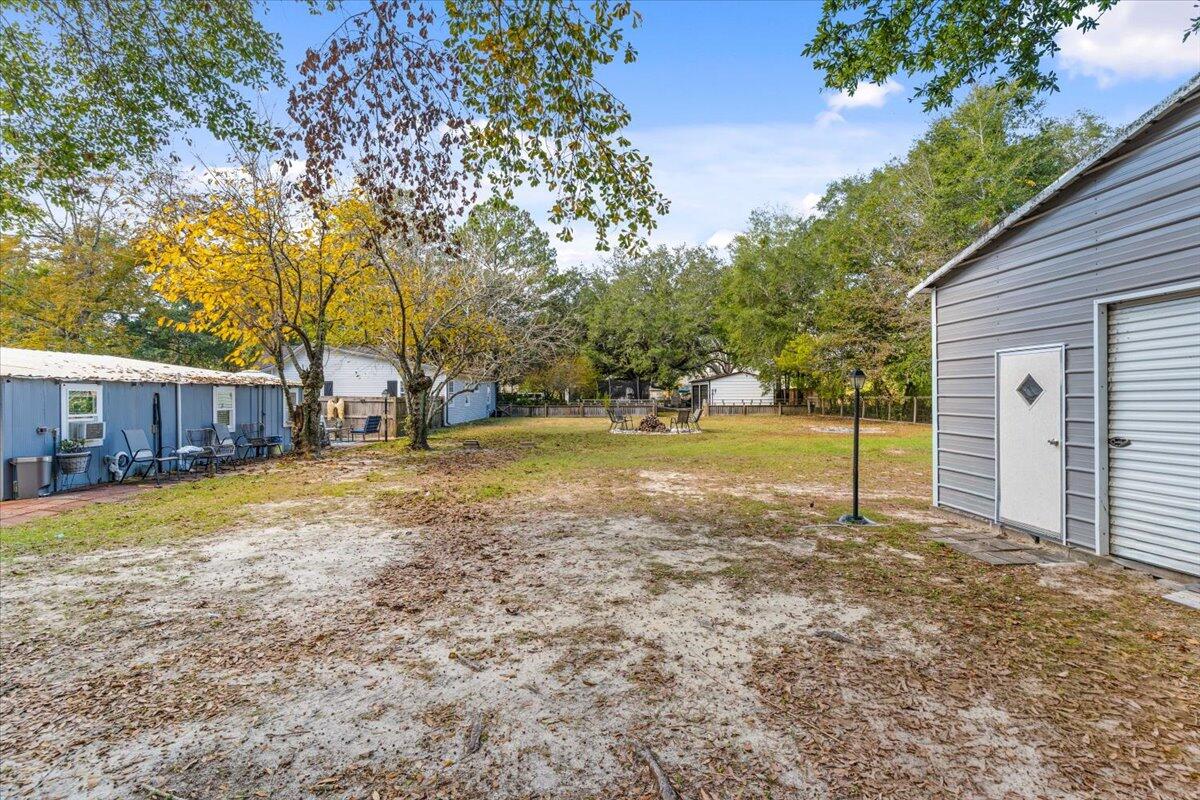 3562 Bob Tolbert Road Navarre, FL 32566 - Photo 47 of 55 a view of a house with backyard and tree