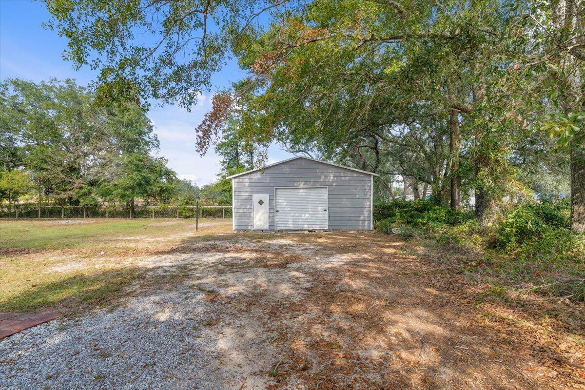 3562 Bob Tolbert Road Navarre, FL 32566 - Photo 48 of 55 a house with yard in front of it